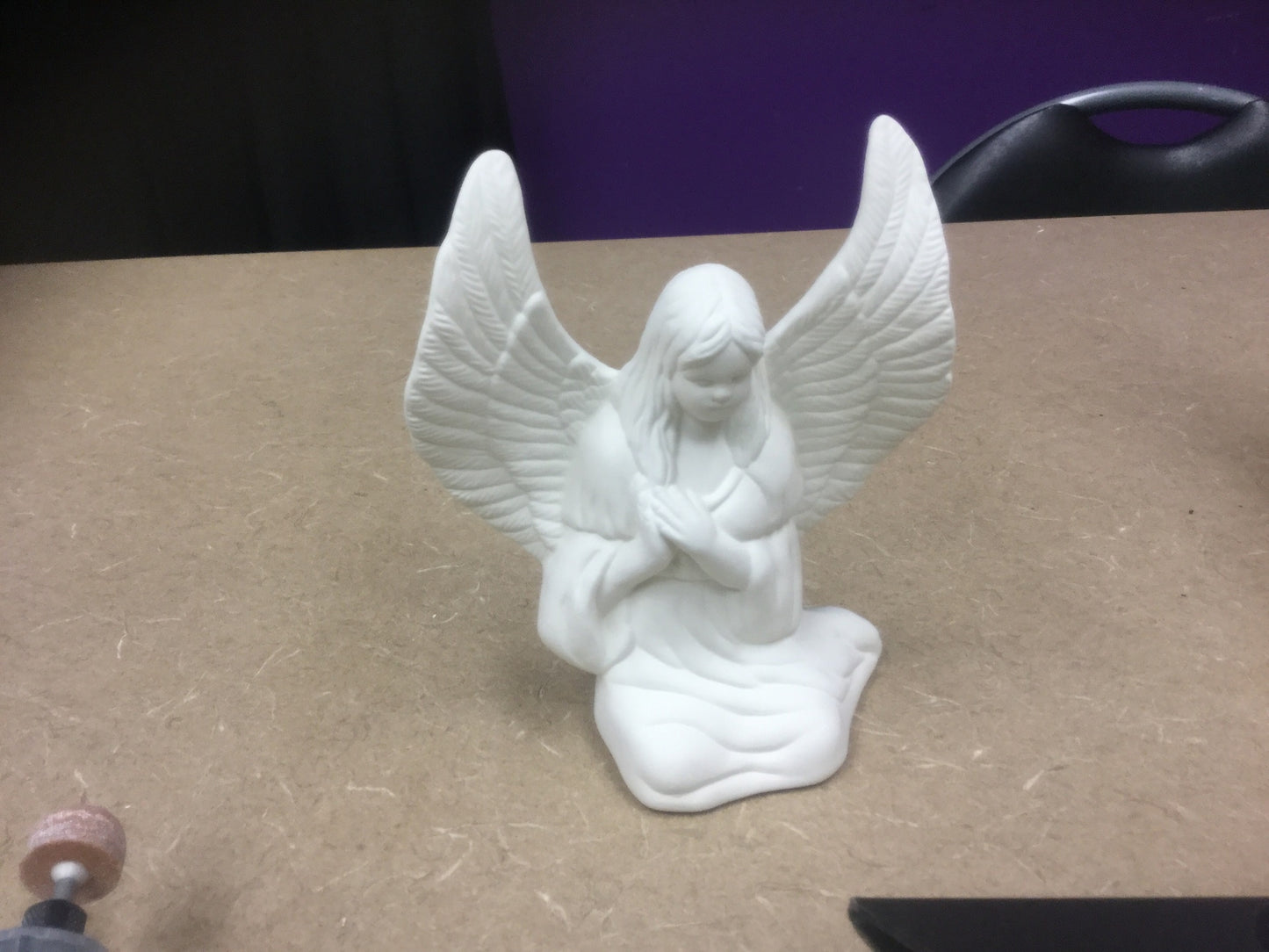 Angel kneeling with wings out