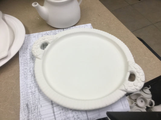 Flower handled rimmed plate