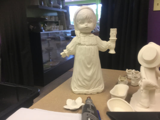 Boy in nightgown with candle