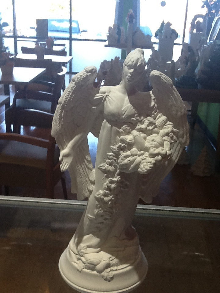 Angel statue holding vegetables