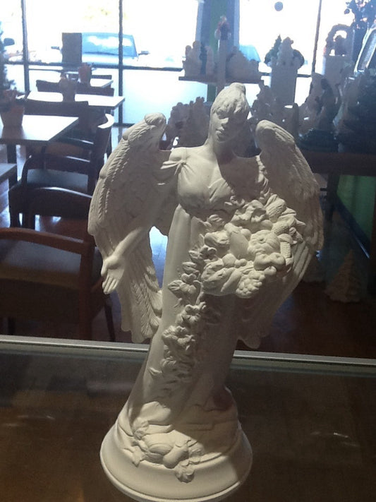 Angel statue holding vegetables